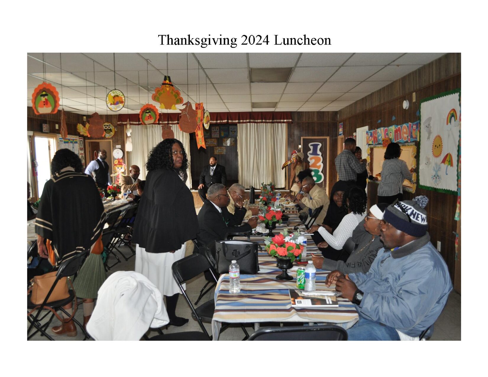 A group of people sitting at tables with food.