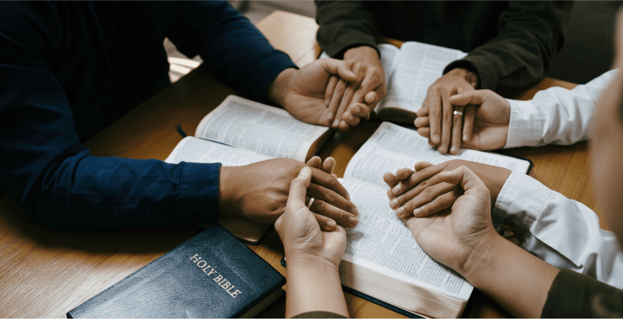 A group of people sitting around some books