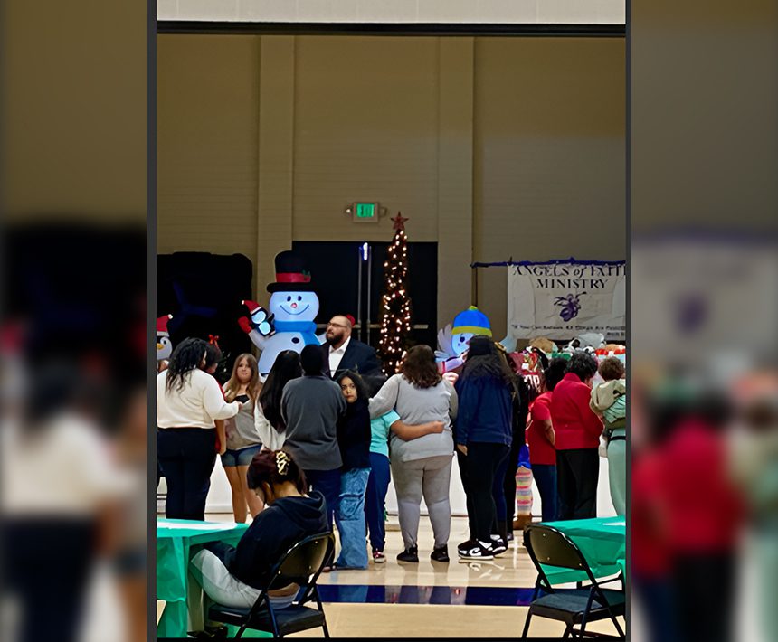 A group of people standing around in front of a stage.