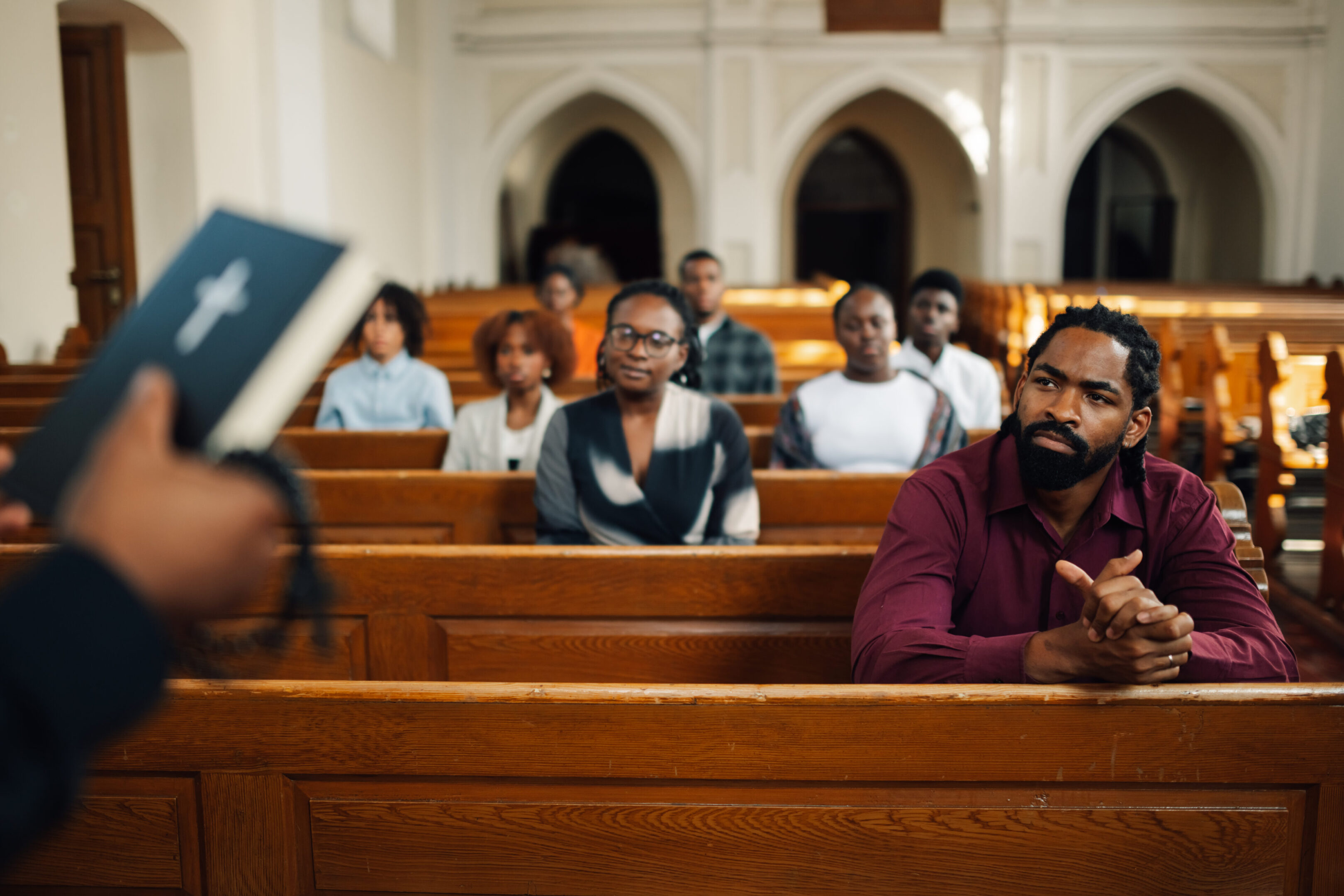 A group of people sitting in pews at church.