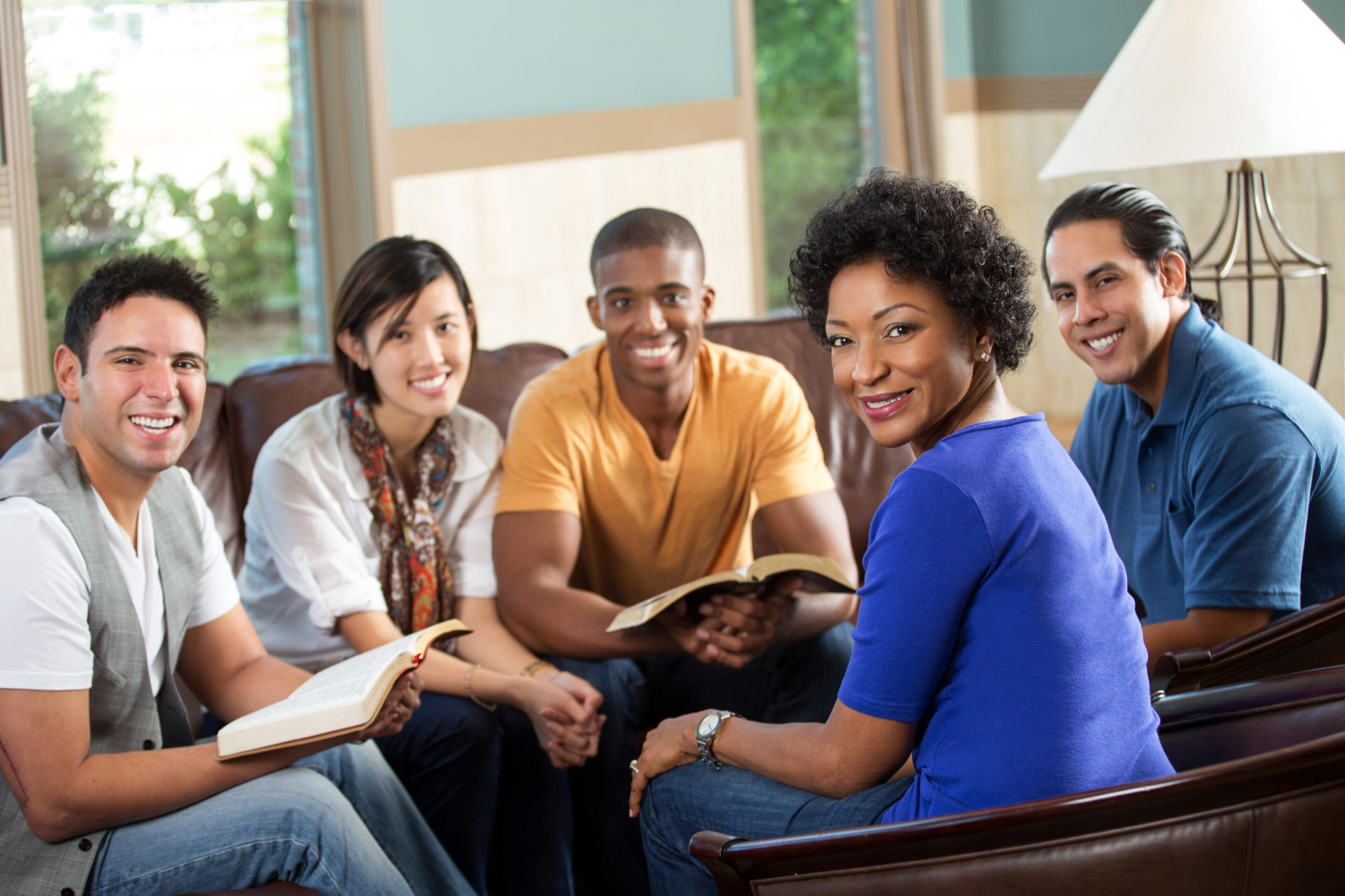 A group of people sitting around each other.